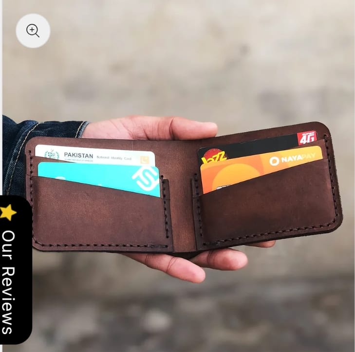The Drifter Travel Wallet open, holding an ID card and cash