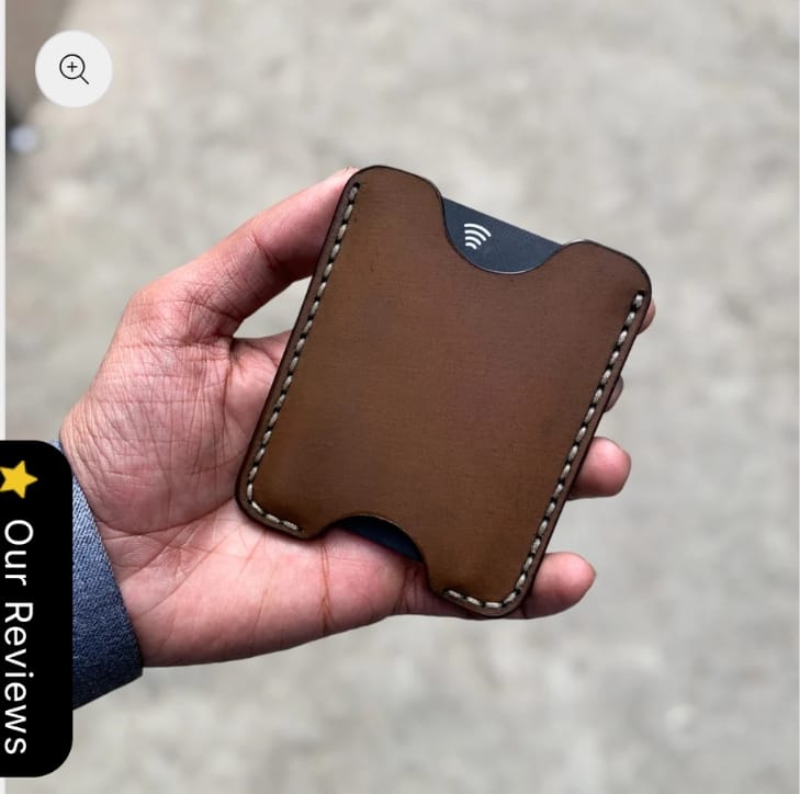 The Maverick Card Sleeve held in hand, showing a contactless card seated in the slot